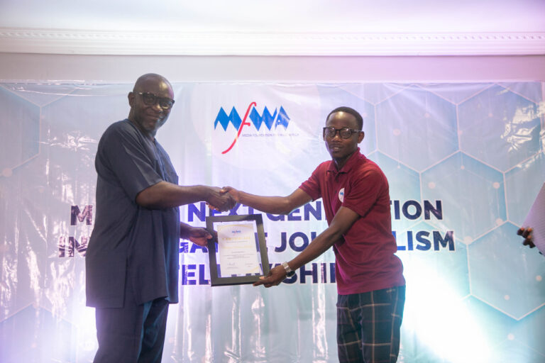 Prosper (right) receiving his certificate at the programme that outdoored the first cohort of the Next Generation Investigative Journalism Fellowship